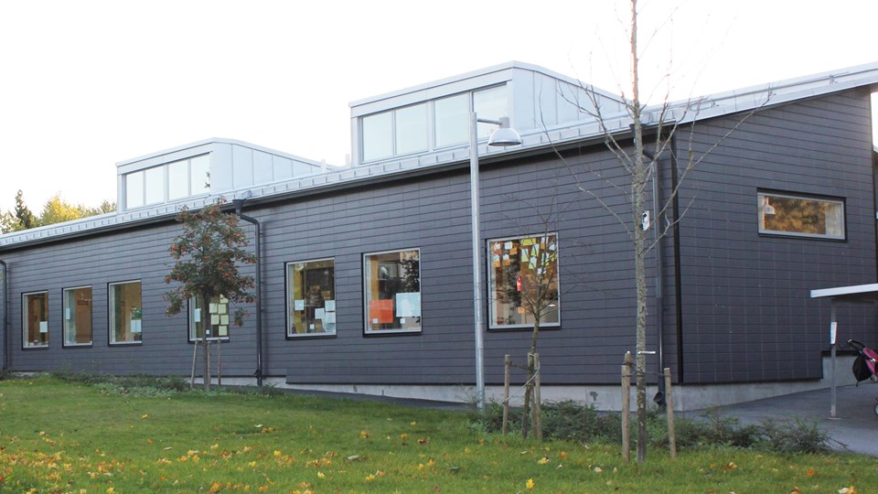 Förskolan Skogens grå fasad med stora inglasade takkupoler.